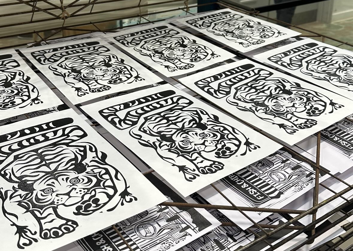 Linoprint of tigers.